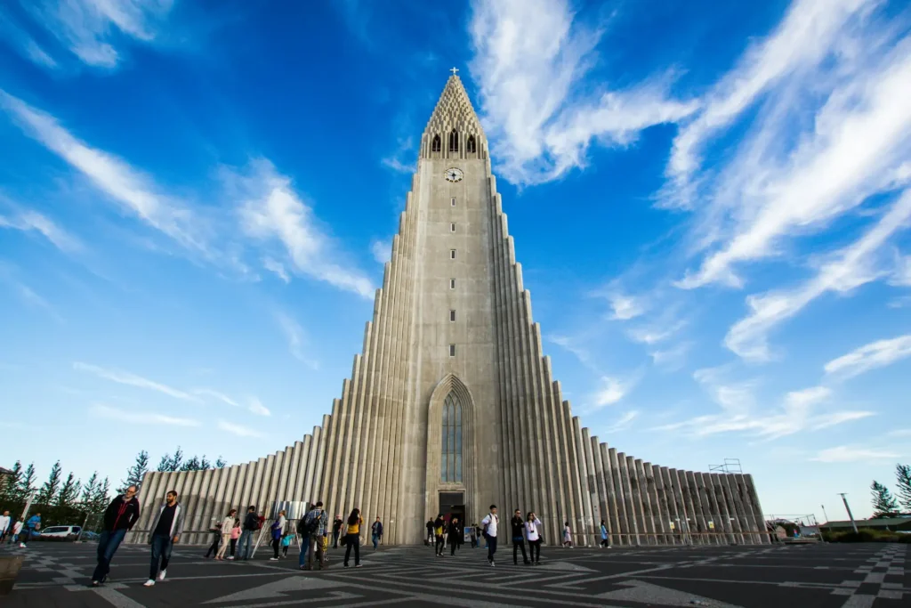 Hallgrimskirkja church in Reykjavik with blue sky and visitors