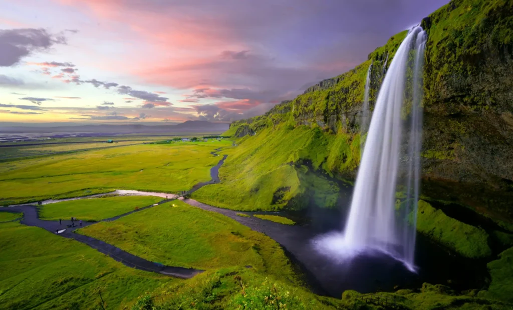 Icelandic waterfall surrounded by green landscape